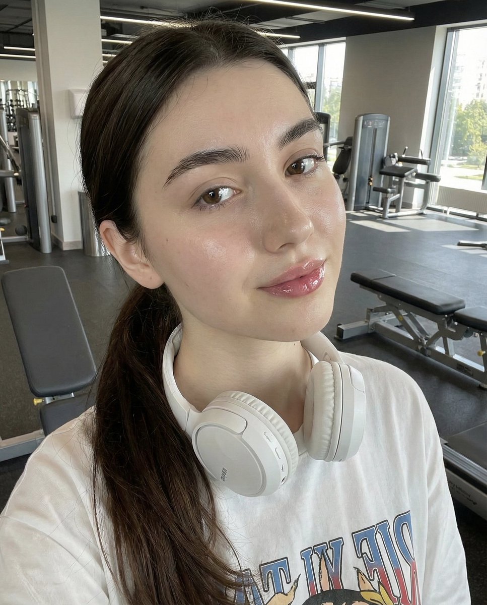 Young Woman in Gym Selfie with Headphones - Fitness Portrait